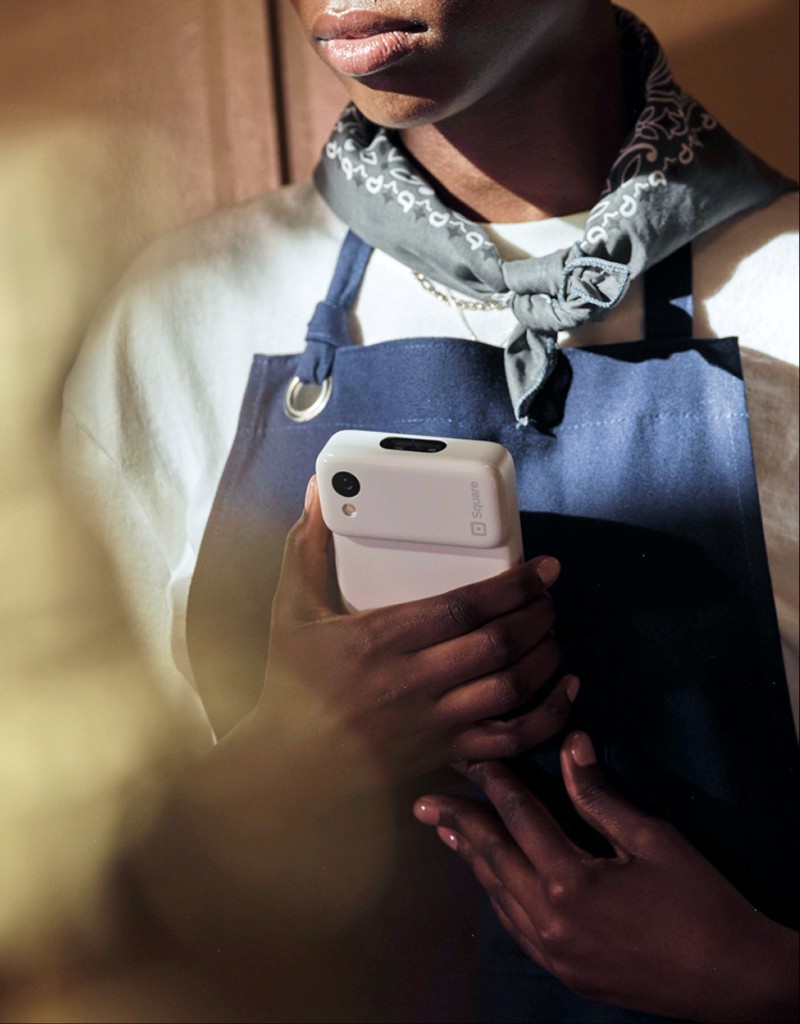 Square handheld lifestyle portrait with device in hand