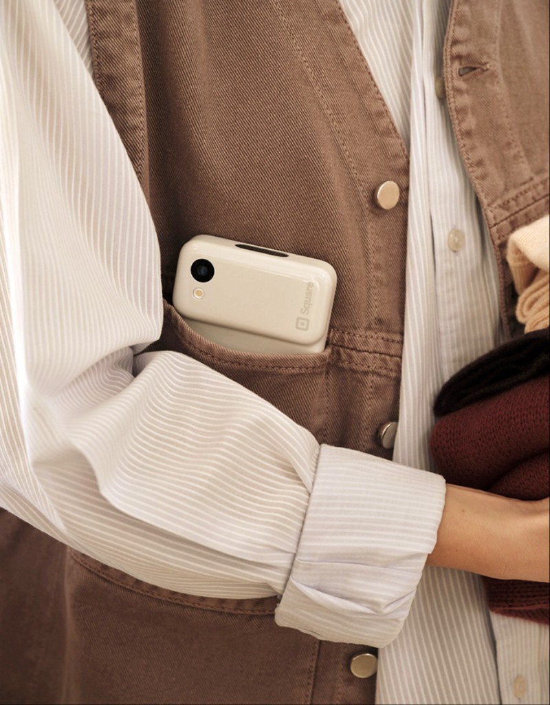Square handheld lifestyle portrait with device in vest pocket